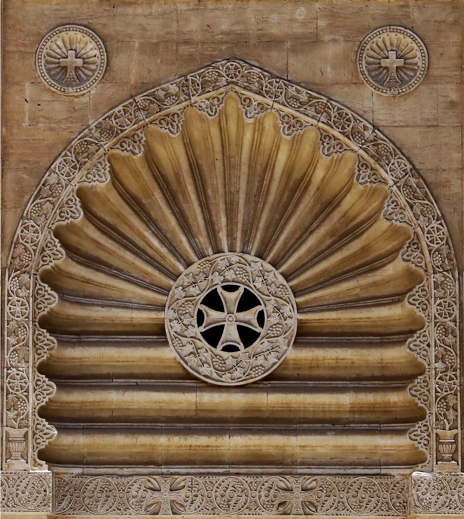 Arch of the facade with radiation decorations